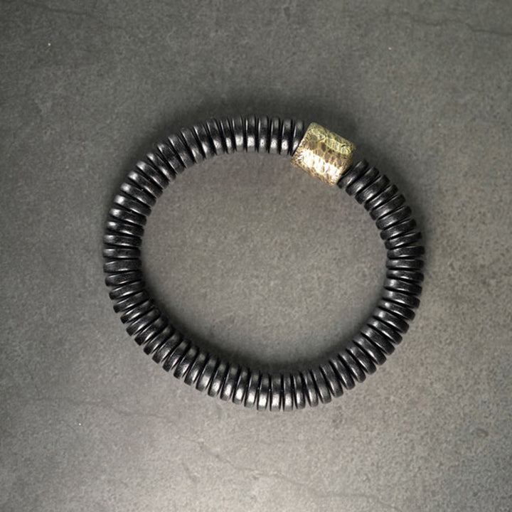 Pulsera de calma con Buddha Stones, madera de ébano, cobre y latón