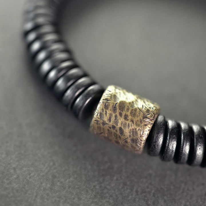 Pulsera de calma con Buddha Stones, madera de ébano, cobre y latón