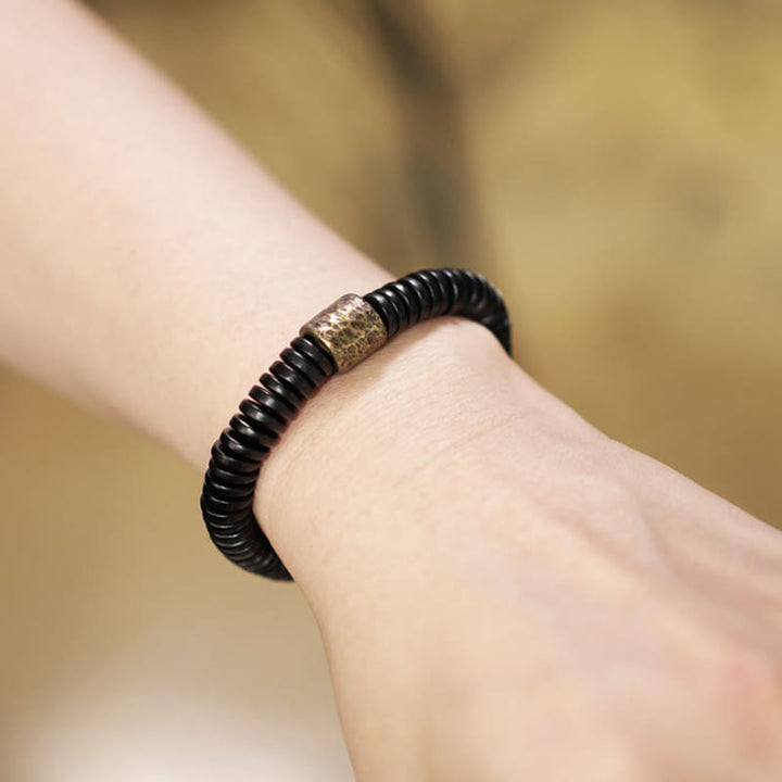 Pulsera de calma con Buddha Stones, madera de ébano, cobre y latón