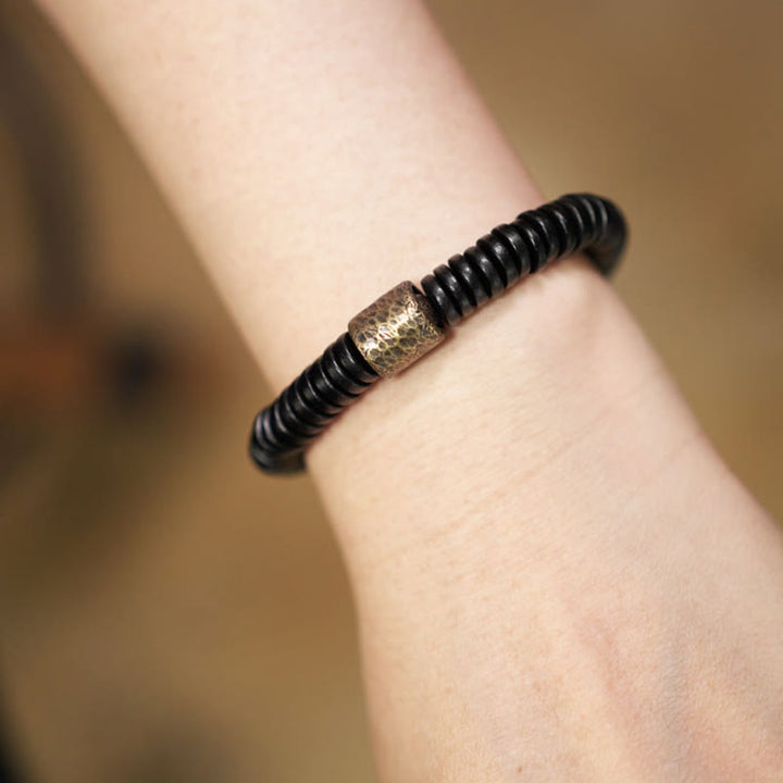 Pulsera de calma con Buddha Stones, madera de ébano, cobre y latón