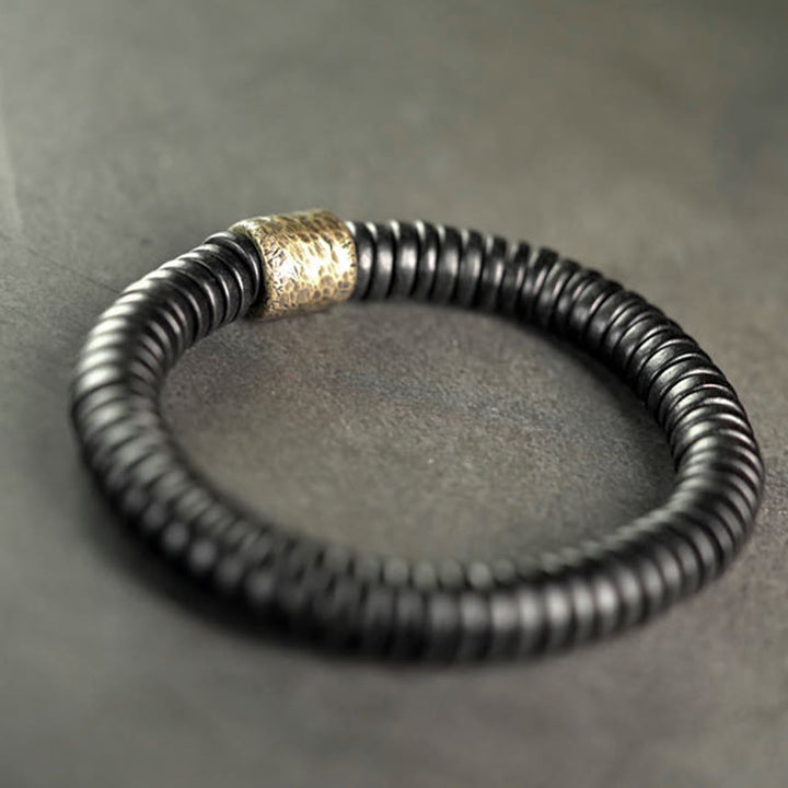 Pulsera de calma con Buddha Stones, madera de ébano, cobre y latón