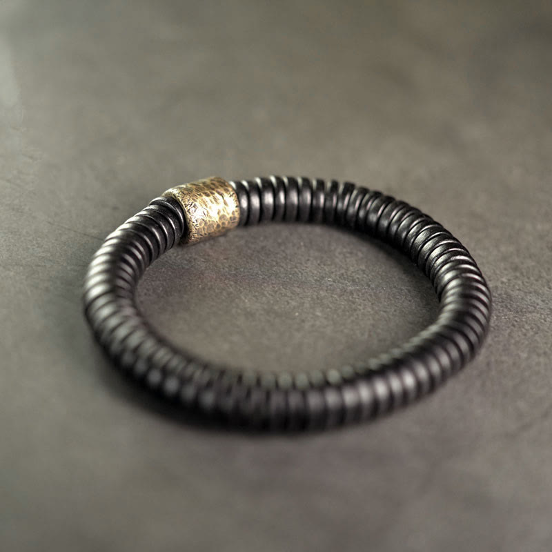 Pulsera de calma con Buddha Stones, madera de ébano, cobre y latón