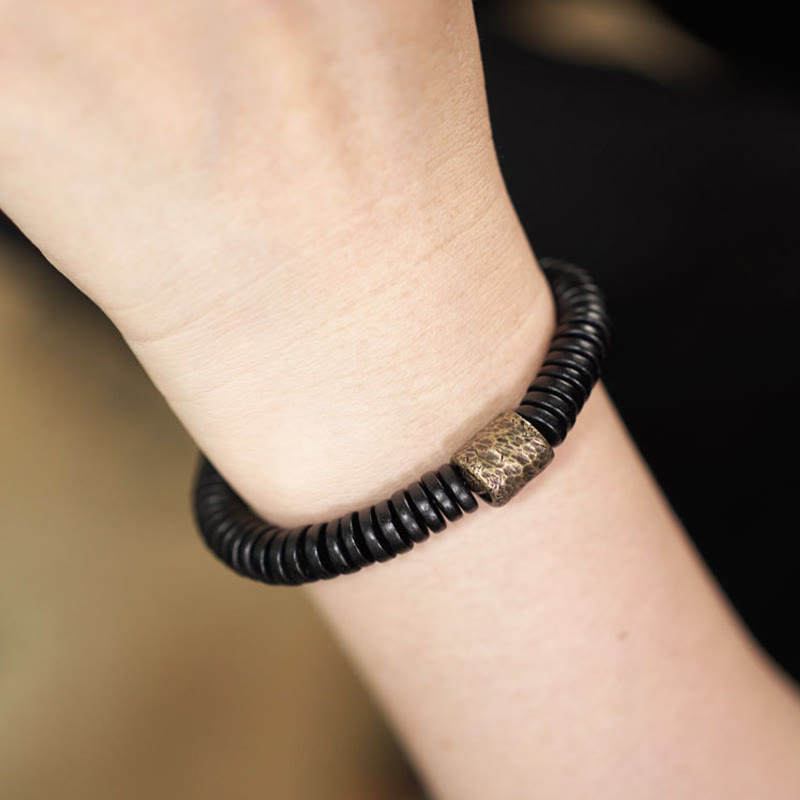 Pulsera de calma con Buddha Stones, madera de ébano, cobre y latón