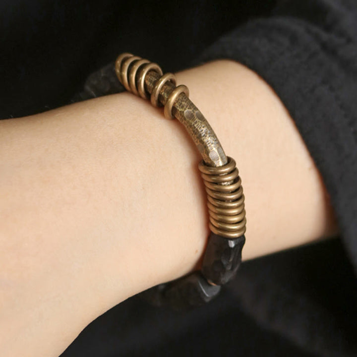 Pulsera de la paz con anillo circular de cobre, latón, madera y ébano con Buddha Stones