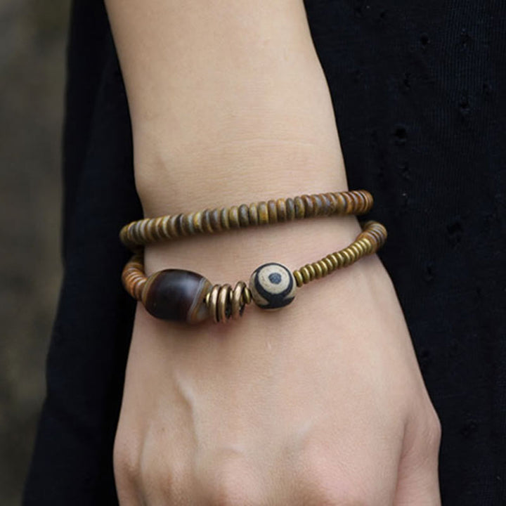 Pulsera de doble vuelta con cuentas Dzi de latón, cobre, sándalo verde, madera de ébano y Buddha Stones
