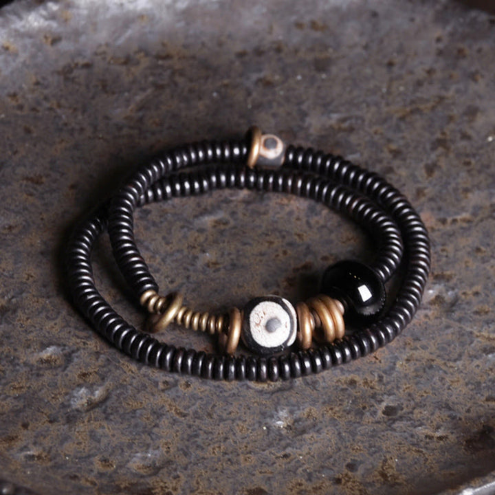Pulsera de doble vuelta con cuentas Dzi de latón, cobre, sándalo verde, madera de ébano y Buddha Stones