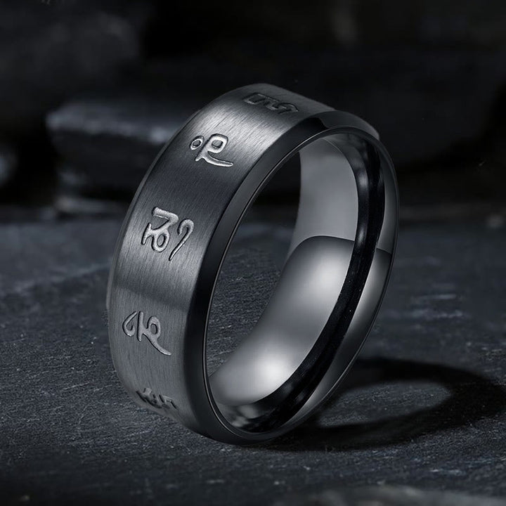 Anillo de equilibrio de acero y titanio con mantra Jambhala negro y Buddha Stones