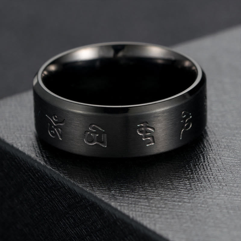 Anillo de equilibrio de acero y titanio con mantra Jambhala negro y Buddha Stones