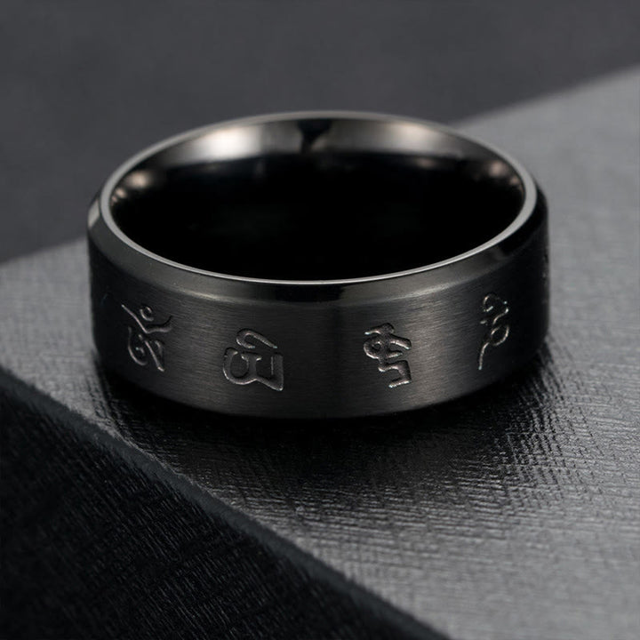Anillo de equilibrio de acero y titanio con mantra Jambhala negro y Buddha Stones