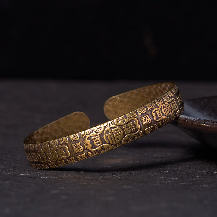Pulsera de cobre y latón con símbolo de la suerte de Buddha Stones de las cien bendiciones
