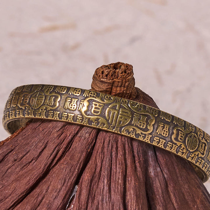 Pulsera de cobre y latón con símbolo de la suerte de Buddha Stones de las cien bendiciones