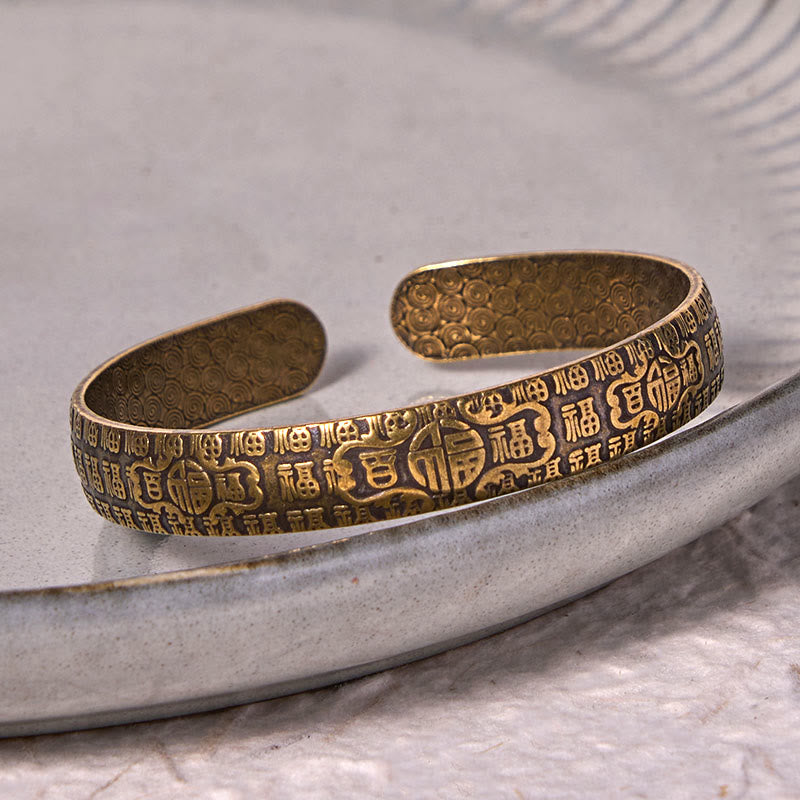 Pulsera de cobre y latón con símbolo de la suerte de Buddha Stones de las cien bendiciones