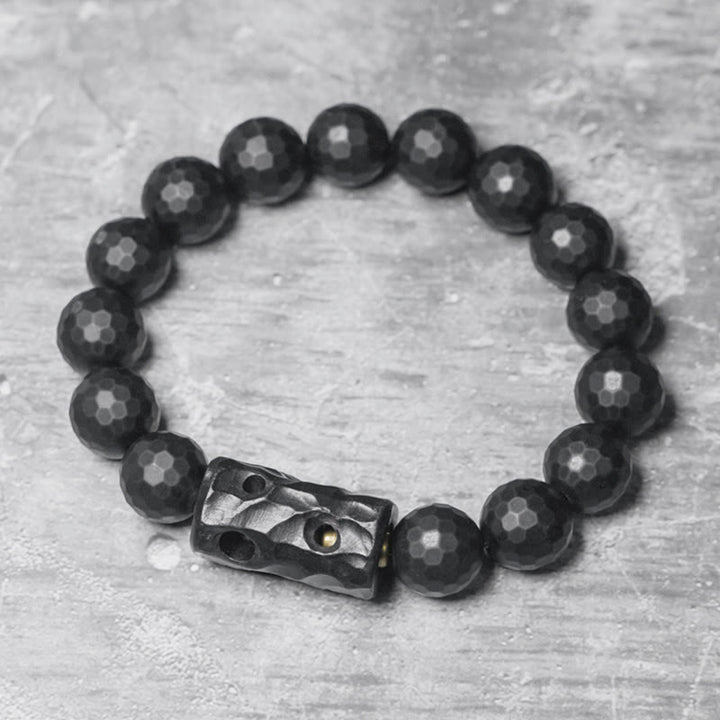 Pulsera protectora de ébano y ónix negro con superficie mate esmerilada y Buddha Stones