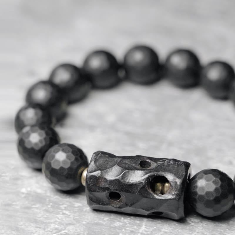 Pulsera protectora de ébano y ónix negro con superficie mate esmerilada y Buddha Stones
