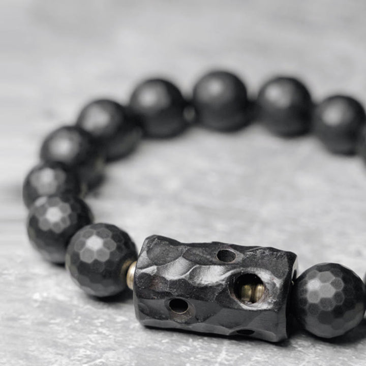 Pulsera protectora de ébano y ónix negro con superficie mate esmerilada y Buddha Stones