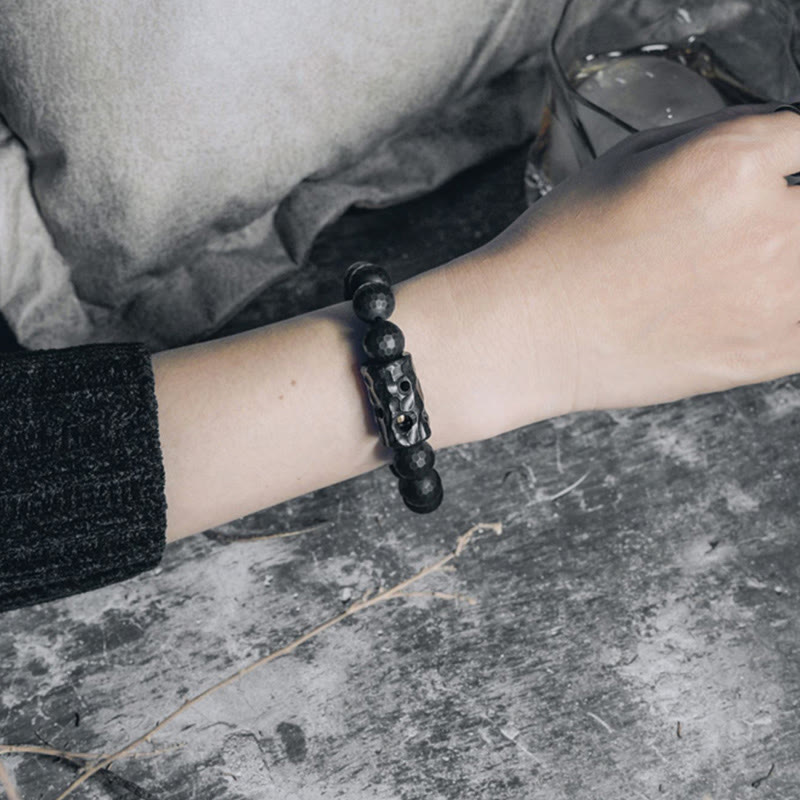Pulsera protectora de ébano y ónix negro con superficie mate esmerilada y Buddha Stones
