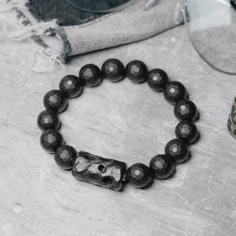 Pulsera protectora de ébano y ónix negro con superficie mate esmerilada y Buddha Stones