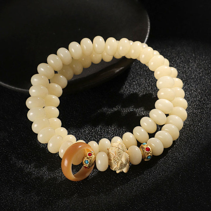 Pulsera de doble vuelta con Buddha Stones de Bodhi y madera de durazno y loto para la riqueza