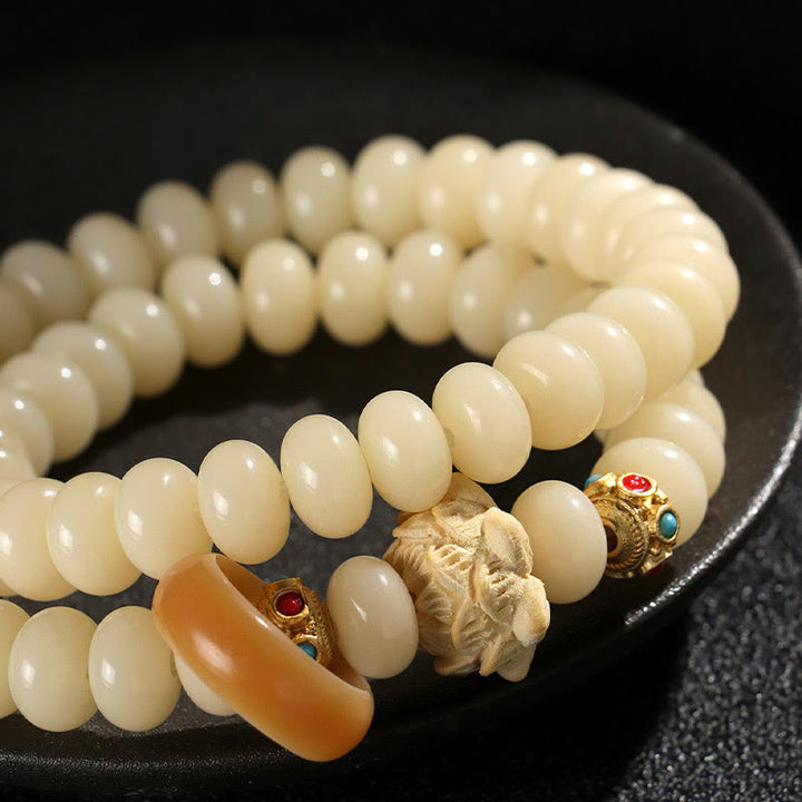 Pulsera de doble vuelta con Buddha Stones de Bodhi y madera de durazno y loto para la riqueza