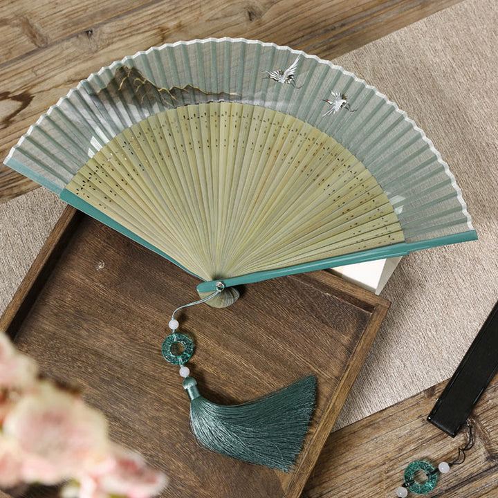 Abanico plegable de bambú de mano con diseño de grulla de río y montaña retro con Buddha Stones