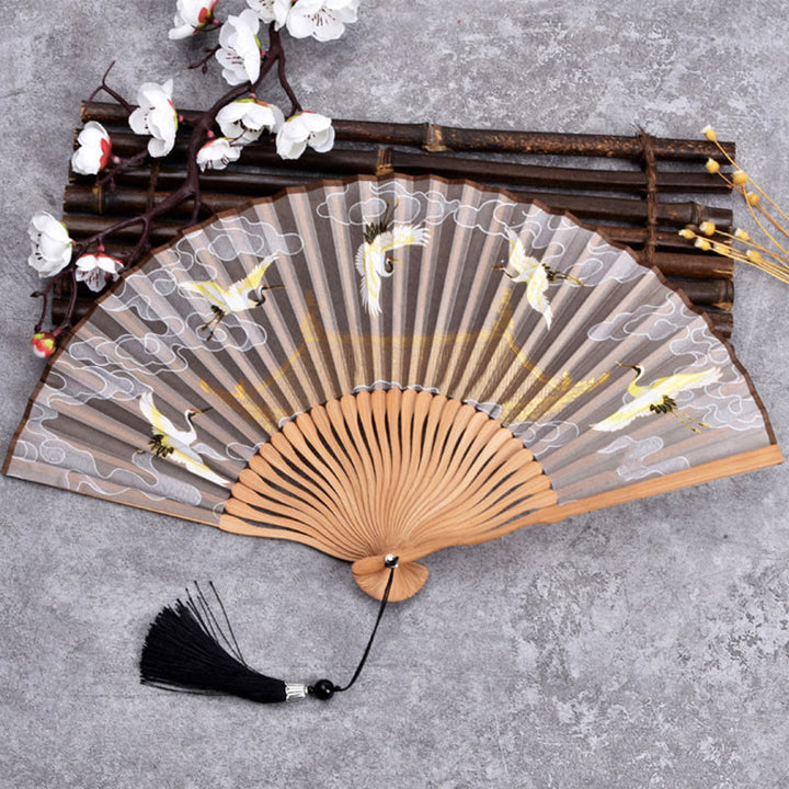 Abanico plegable de bambú con tela de lino y algodón de color liso con degradado de grullas y piedras de Buddha Stones y nubes auspiciosas