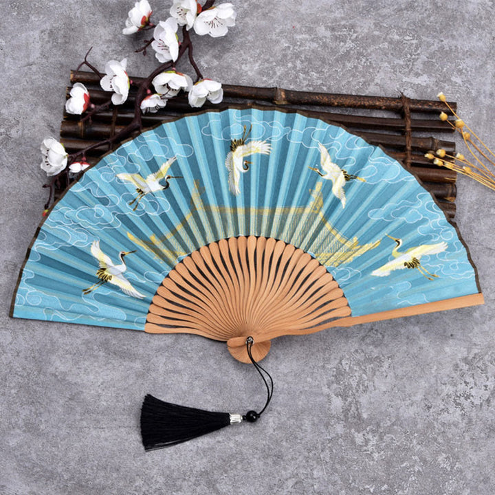 Abanico plegable de bambú con tela de lino y algodón de color liso con degradado de grullas y piedras de Buddha Stones y nubes auspiciosas