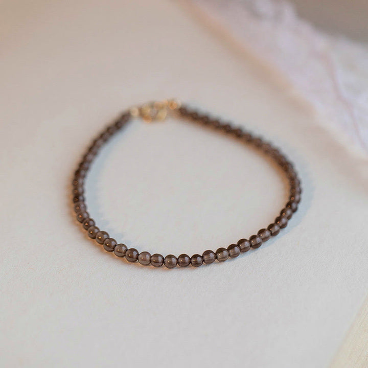 Pulsera de éxito con cuentas ultrafinas de obsidiana negra y cuarzo ahumado de Buddha Stones