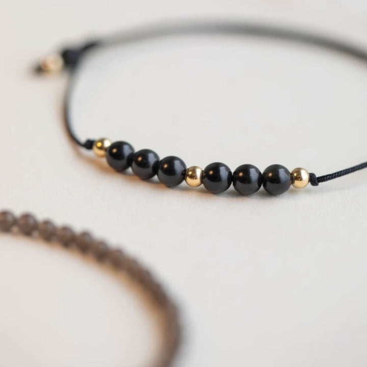 Pulsera de éxito con cuentas ultrafinas de obsidiana negra y cuarzo ahumado de Buddha Stones