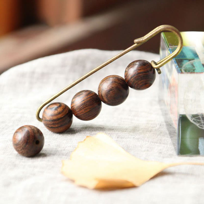 Broche curativo con cuentas de peltogyne, agathis alba, sándalo y madera de ébano de Buddha Stones