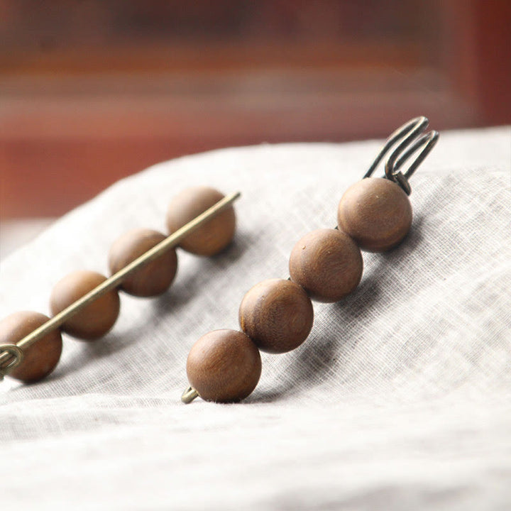Broche curativo con cuentas de peltogyne, agathis alba, sándalo y madera de ébano de Buddha Stones