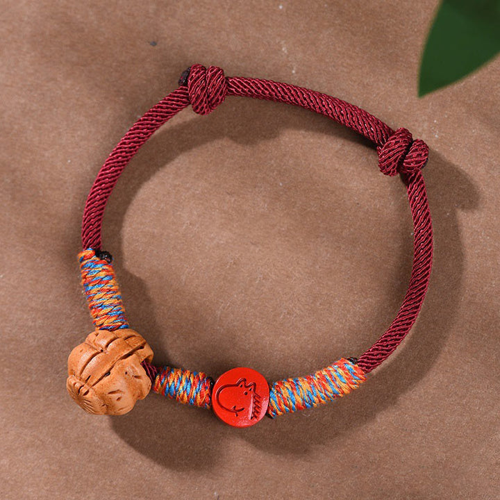 Pulsera de la suerte hecha a mano con Buddha Stones y cinabrio de hueso de melocotón con hilo rojo del zodíaco chino