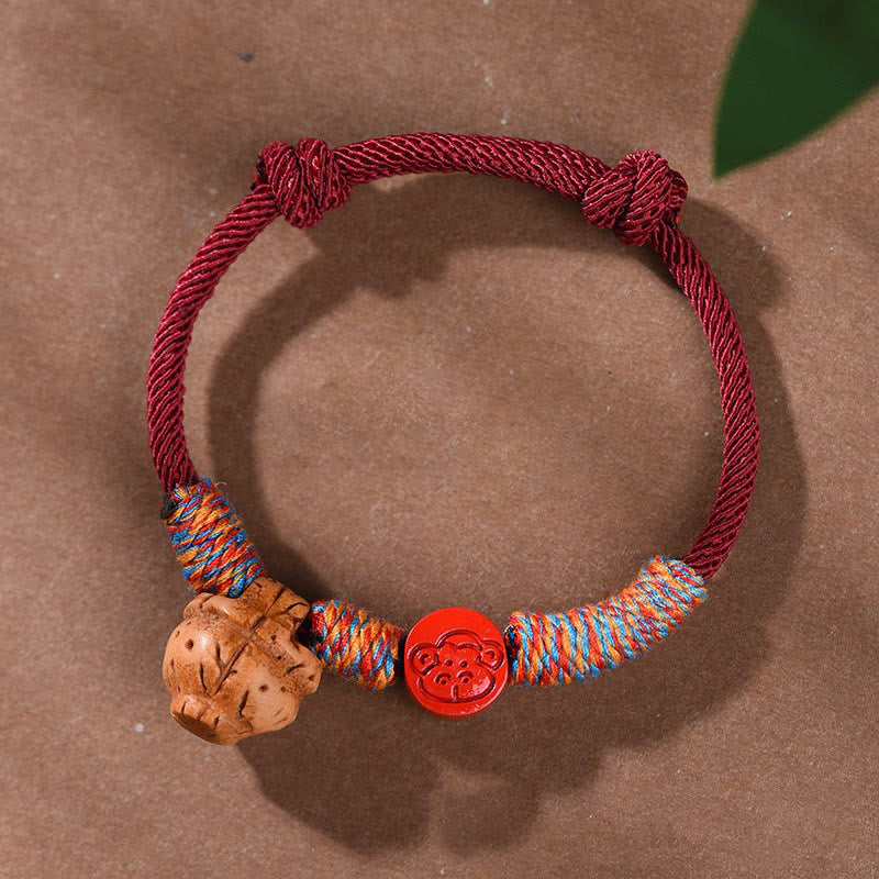 Pulsera de la suerte hecha a mano con Buddha Stones y cinabrio de hueso de melocotón con hilo rojo del zodíaco chino
