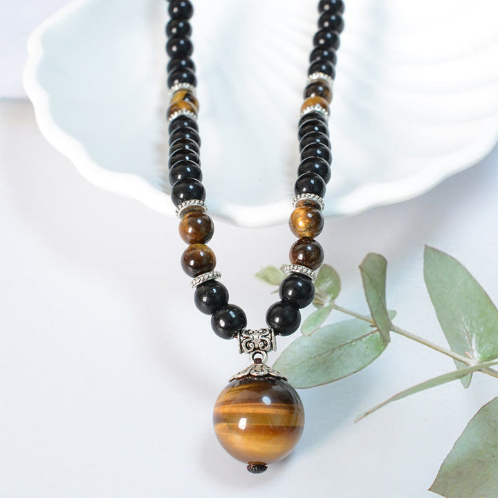 Collar con colgante de ojo de tigre y obsidiana negra con Buddha Stones para fortalecer