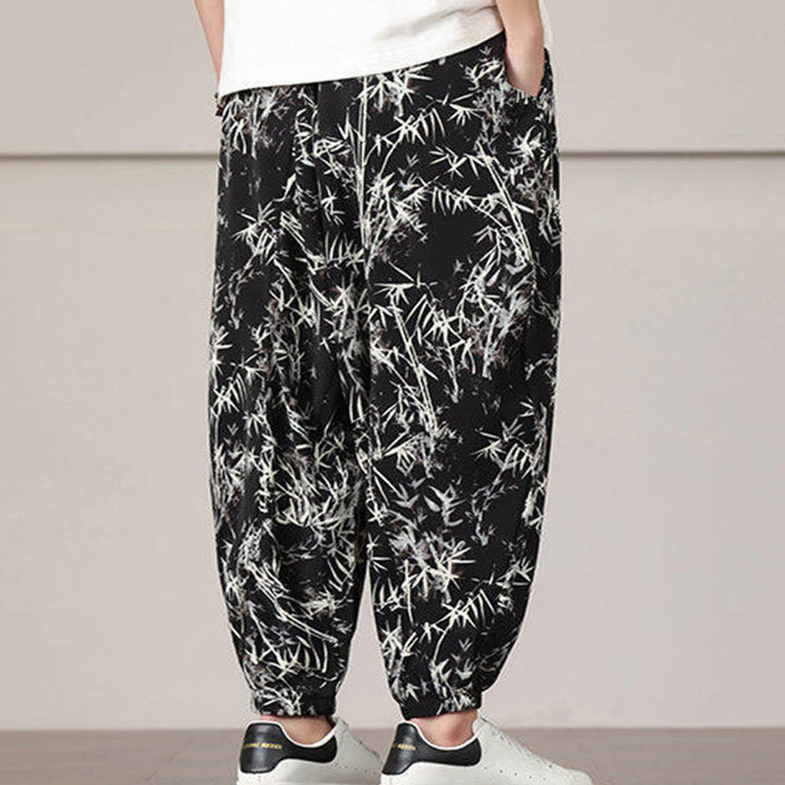 Pantalones harén con cordón y bolsillos para hombre con estampado de hojas de bambú y Buddha Stones