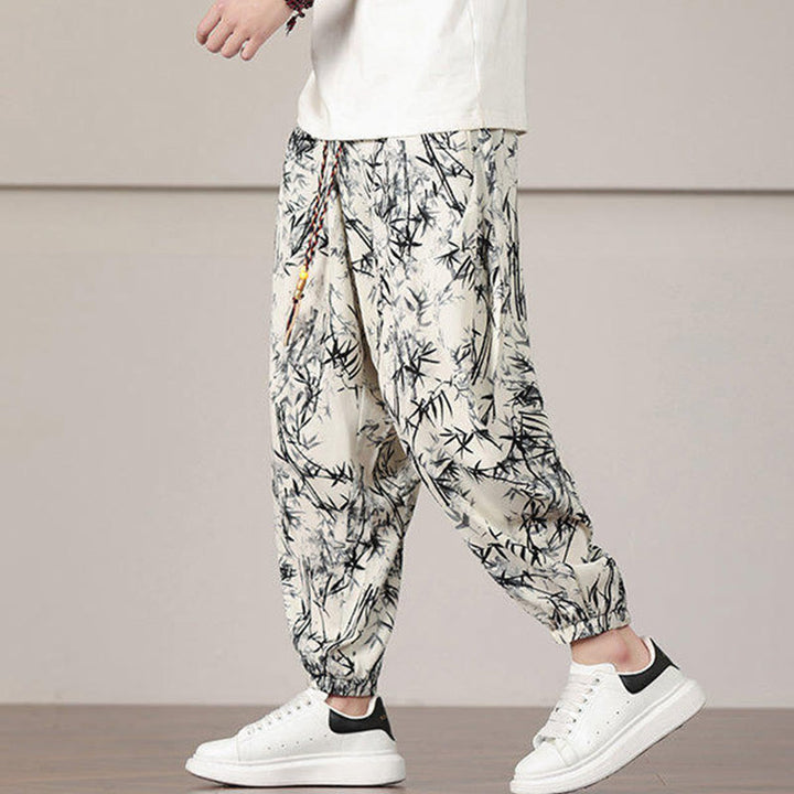 Pantalones harén con cordón y bolsillos para hombre con estampado de hojas de bambú y Buddha Stones