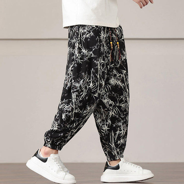Pantalones harén con cordón y bolsillos para hombre con estampado de hojas de bambú y Buddha Stones