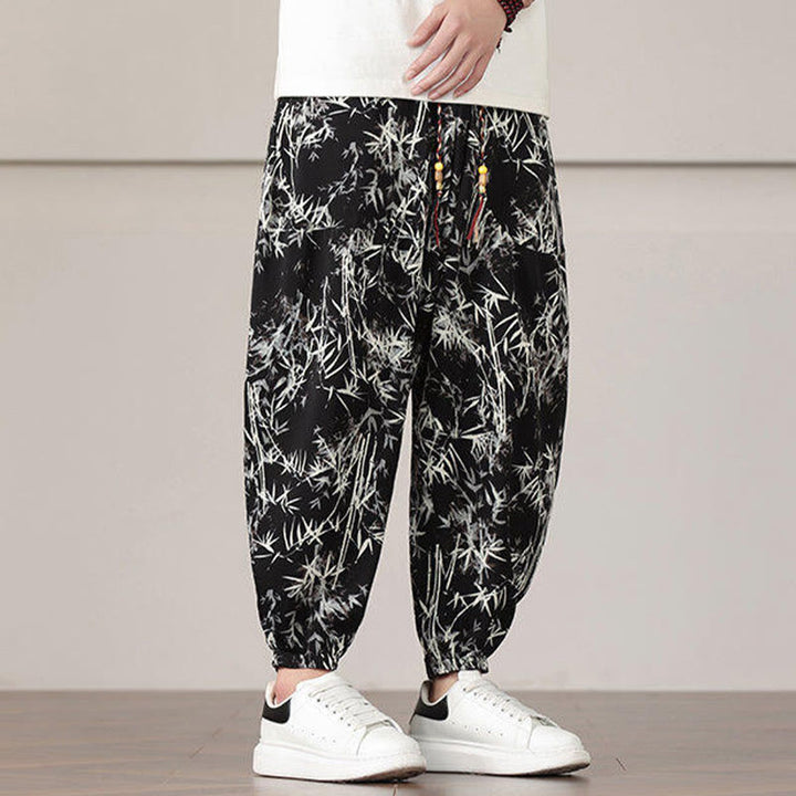 Pantalones harén con cordón y bolsillos para hombre con estampado de hojas de bambú y Buddha Stones