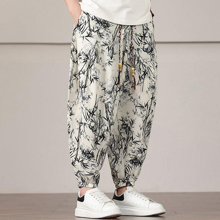 Pantalones harén con cordón y bolsillos para hombre con estampado de hojas de bambú y Buddha Stones