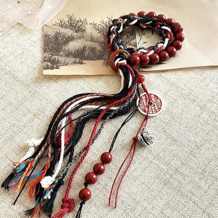 Pulsera de borlas de cuerda roja de doble capa con cinabrio y piedras de Buddha Stones tibetanas que gastan dinero