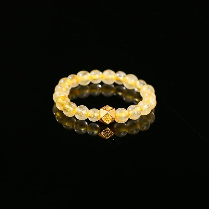 Anillo elástico de riqueza con cuentas de cuarzo rutilado dorado de 3 mm de Buddha Stones