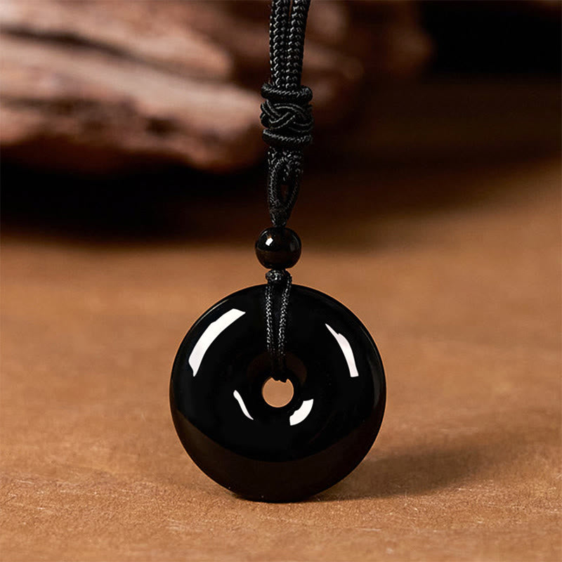 Collar con colgante de cuerda de fuerza con hebilla de paz y obsidiana negra natural de Buddha Stones