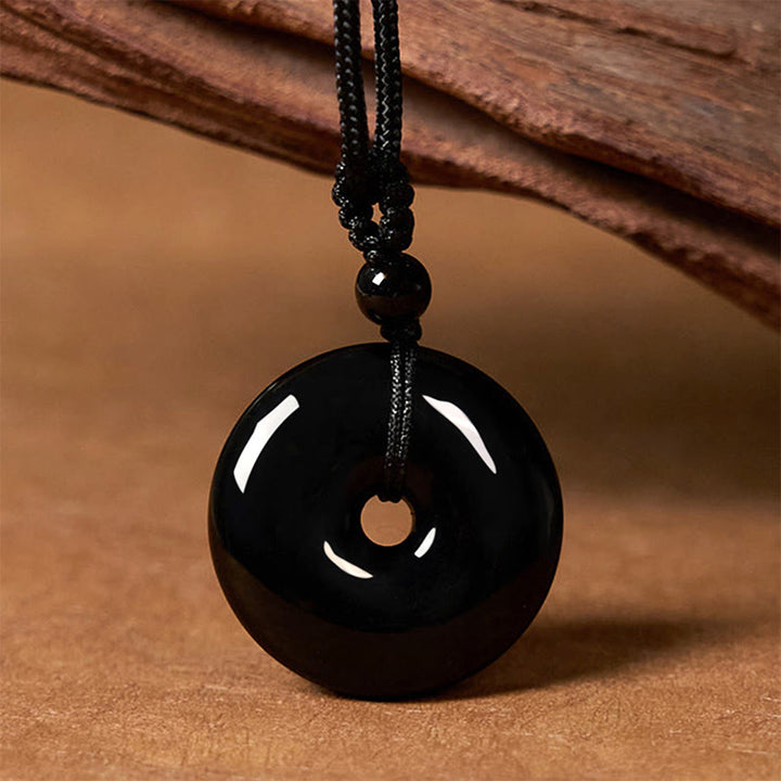 Collar con colgante de cuerda de fuerza con hebilla de paz y obsidiana negra natural de Buddha Stones