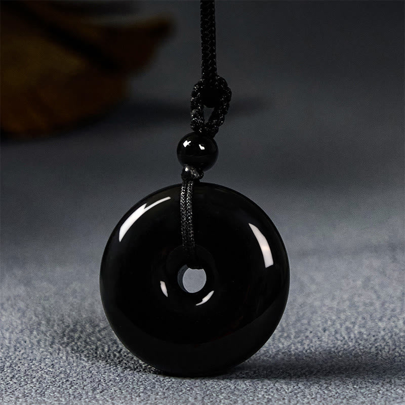 Collar con colgante de cuerda de fuerza con hebilla de paz y obsidiana negra natural de Buddha Stones