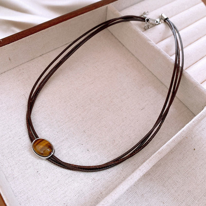 Collar con colgante de cuerda de cera con protección elíptica de ojo de tigre natural y Buddha Stones