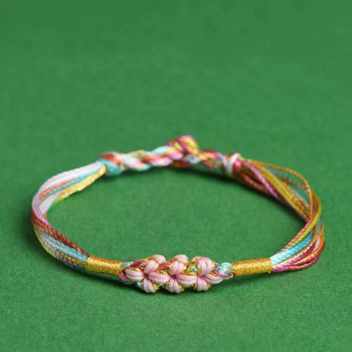 Pulsera trenzada zongzi con nudo de flor de durazno y cuerda colorida de Buddha Stones