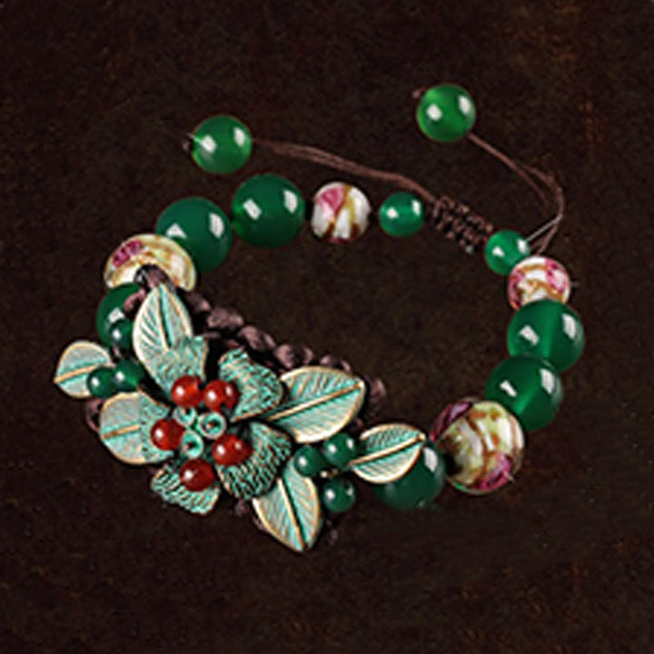Pulsera de soporte con nudo trenzado y cuentas de flores de vidrio de ágata verde de Buddha Stones