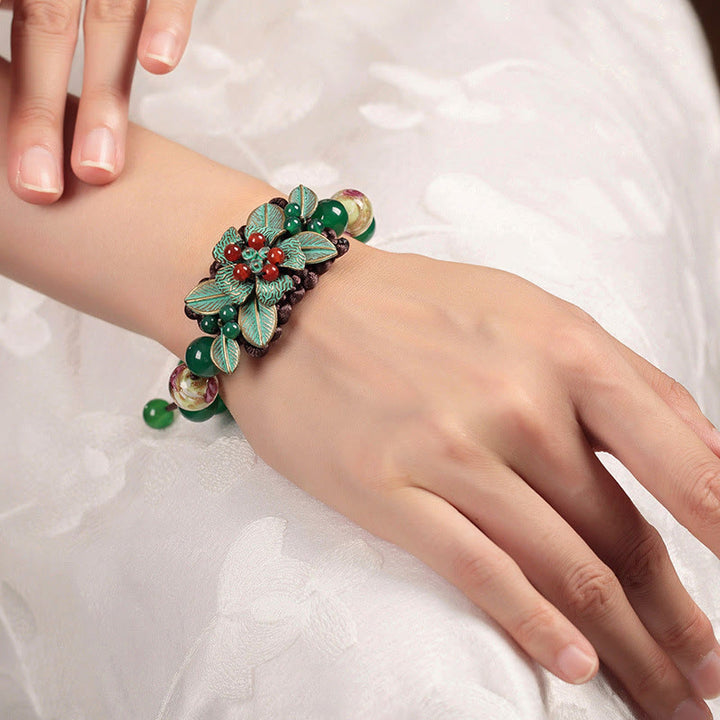 Pulsera de soporte con nudo trenzado y cuentas de flores de vidrio de ágata verde de Buddha Stones