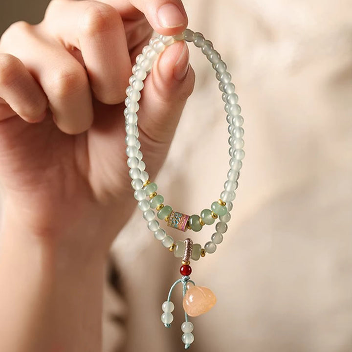 Pulsera de positividad con múltiples círculos de Buddha Stones, aventurina natural, vainas de loto y bambú de la suerte.