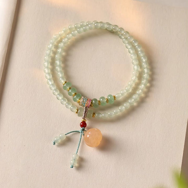 Pulsera de positividad con múltiples círculos de Buddha Stones, aventurina natural, vainas de loto y bambú de la suerte.