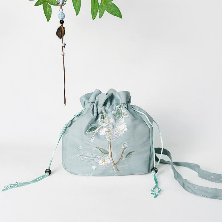 Bolso bandolera de lona con bordado de Buddha Stones, flores verdes y hojas.